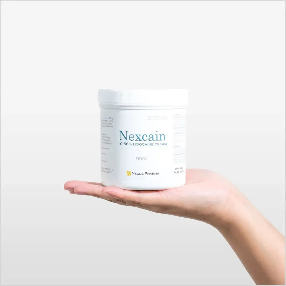 Jar of Derma Essence Nexcain Lidocaine Cream for numbing, made in Korea, shown in a clear container with cream inside.